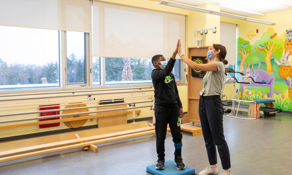 An adult and a child high-fiving